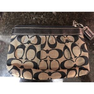 Black and gray Coach wristlet